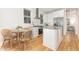Modern kitchen with stainless steel appliances, island, and an adjacent dining area at 902 B Oakland Ave, Durham, NC 27705
