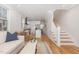 Bright living room with hardwood floors, open layout to the kitchen, and staircase at 902 B Oakland Ave, Durham, NC 27705