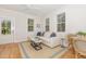 Cozy living room featuring a comfortable sectional, natural light, and stylish decor at 902 B Oakland Ave, Durham, NC 27705
