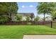 Fenced backyard with a well-manicured lawn, patio, and mature landscaping at 923 Peltier Dr, Cary, NC 27519