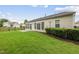 A beautiful backyard with lush grass, a patio, and a black iron fence at 923 Peltier Dr, Cary, NC 27519