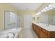 Bright bathroom featuring a double sink vanity, soaking tub and separate shower at 923 Peltier Dr, Cary, NC 27519