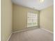 Bedroom with neutral carpet, walls, and a window at 923 Peltier Dr, Cary, NC 27519