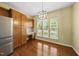 Bright dining area with hardwood floors, built-in cabinetry, and natural light from large windows at 923 Peltier Dr, Cary, NC 27519