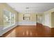 Spacious dining area showcasing hardwood floors, white trim, and a modern chandelier at 923 Peltier Dr, Cary, NC 27519