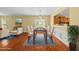 Traditional dining room featuring hardwood floors, a wooden table, and seating for six under an elegant chandelier at 923 Peltier Dr, Cary, NC 27519