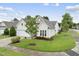 Inviting one-story home boasts a well-kept lawn, convenient garage, and neatly trimmed greenery at 923 Peltier Dr, Cary, NC 27519