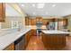 Spacious kitchen featuring wood cabinets, stainless steel appliances, and a center island with white countertop at 923 Peltier Dr, Cary, NC 27519