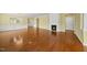 Open-concept living space with hardwood floors and a fireplace focal point at 923 Peltier Dr, Cary, NC 27519