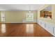Spacious living room with hardwood floors, view into kitchen, and lots of natural light at 923 Peltier Dr, Cary, NC 27519