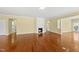 Bright living room features hardwood floors and an elegant fireplace at 923 Peltier Dr, Cary, NC 27519