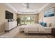 Staged main bedroom offers a large bed and plenty of natural light at 923 Peltier Dr, Cary, NC 27519