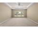 Empty Main bedroom features tray ceiling, neutral carpet and a large window at 923 Peltier Dr, Cary, NC 27519