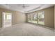 Main bedroom featuring neutral walls, carpet, a tray ceiling, and an ensuite bathroom at 923 Peltier Dr, Cary, NC 27519