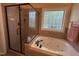 Bathroom featuring a glass-enclosed shower, soaking tub, and decorative tile work at 929 Sagamore Dr, Louisburg, NC 27549