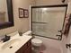 Bathroom with a single sink vanity, framed mirror, and shower with sliding glass door at 929 Sagamore Dr, Louisburg, NC 27549