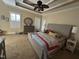 Bright bedroom with tray ceilings, large windows, and a comfortable bed with colorful pillows at 929 Sagamore Dr, Louisburg, NC 27549