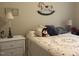 Charming bedroom with a floral quilt, wicker nightstand, and decorative rocking horse at 929 Sagamore Dr, Louisburg, NC 27549