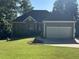 Charming single-story home with stone and siding, showcasing an attached garage at 929 Sagamore Dr, Louisburg, NC 27549