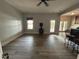 Open-concept living room featuring wood floors, a wood-burning stove, and a view to the outdoors at 929 Sagamore Dr, Louisburg, NC 27549