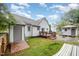 Backyard view featuring a deck, a shed, a partial hammock, and green lawn at 100 Longneedle Ct, Raleigh, NC 27603