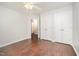 Unfurnished bedroom with a ceiling fan and double closets overlooks an open doorway at 100 Longneedle Ct, Raleigh, NC 27603