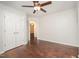 Unfurnished bedroom with a ceiling fan and double closets overlooks an ensuite bathroom at 100 Longneedle Ct, Raleigh, NC 27603