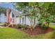 Charming home exterior features a brick chimney and nicely landscaped front yard at 100 Longneedle Ct, Raleigh, NC 27603