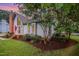 Charming home exterior features a brick chimney and nicely landscaped front yard at 100 Longneedle Ct, Raleigh, NC 27603