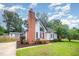 Charming home with large brick chimney, inviting entrance, and well-manicured lawn at 100 Longneedle Ct, Raleigh, NC 27603