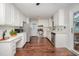 Updated kitchen featuring white cabinets, stainless steel appliances, and modern countertops at 100 Longneedle Ct, Raleigh, NC 27603