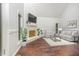 Bright living room features vaulted ceilings, brick fireplace, and hardwood floors at 100 Longneedle Ct, Raleigh, NC 27603