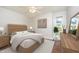Neutral bedroom is decorated with furniture, modern art, and natural light at 100 Longneedle Ct, Raleigh, NC 27603