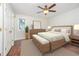 A cozy bedroom with neutral tones features a ceiling fan and matching wooden furniture set at 100 Longneedle Ct, Raleigh, NC 27603