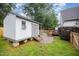Backyard shed featuring a porch, wood and gravel landscape, and a wooden fence at 100 Longneedle Ct, Raleigh, NC 27603