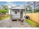 Backyard shed featuring a porch, wood and gravel landscape, and green lawn at 100 Longneedle Ct, Raleigh, NC 27603