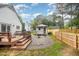 Backyard shed featuring a porch, wood and gravel landscape, and green lawn at 100 Longneedle Ct, Raleigh, NC 27603