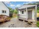 Backyard shed featuring a porch, wood and gravel landscape, and a partial view of a house at 100 Longneedle Ct, Raleigh, NC 27603