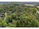 Aerial view of a residential area with houses surrounded by a dense forest of green trees, creating a peaceful environment at 1003 Gloucester Ct, Chapel Hill, NC 27516