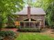 Expansive backyard featuring a screened porch and well-maintained lawn at 1003 Gloucester Ct, Chapel Hill, NC 27516
