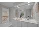 Bright bathroom featuring dual sinks and a large mirror at 1003 Gloucester Ct, Chapel Hill, NC 27516