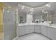 Bright bathroom with white cabinets, tile flooring and a gold-trimmed shower enclosure at 1003 Gloucester Ct, Chapel Hill, NC 27516