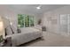 Cozy bedroom with neutral tones and a large window providing natural light at 1003 Gloucester Ct, Chapel Hill, NC 27516