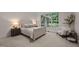 Comfortable bedroom with soft colors and large window offering a view to outside greenery at 1003 Gloucester Ct, Chapel Hill, NC 27516