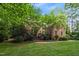 Lovely brick home surrounded by mature trees and manicured lawn at 1003 Gloucester Ct, Chapel Hill, NC 27516