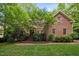 Charming brick home with lush landscaping and inviting entrance at 1003 Gloucester Ct, Chapel Hill, NC 27516
