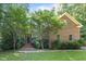 Charming brick home with mature trees, offering a tranquil and private setting at 1003 Gloucester Ct, Chapel Hill, NC 27516