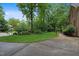 Beautifully landscaped front yard with mature trees, brick walkway, and a well-maintained lawn at 1003 Gloucester Ct, Chapel Hill, NC 27516