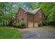 Spacious two-car garage with paved driveway surrounded by lush greenery at 1003 Gloucester Ct, Chapel Hill, NC 27516