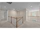 Spacious upstairs hallway with wooden railings and neutral carpet flooring at 1003 Gloucester Ct, Chapel Hill, NC 27516